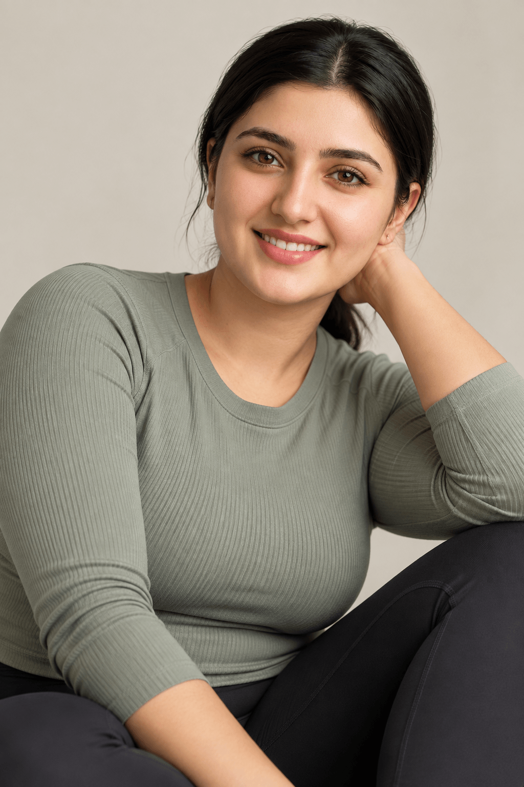 Smiling woman in a sage-green long-sleeved top