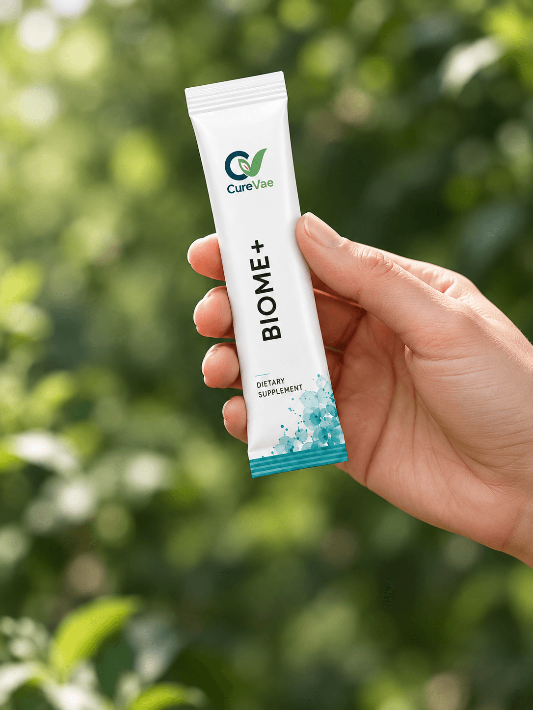 A hand holding a CureVae Biome+ sachet outdoors